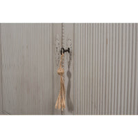 Close-up of latch on rustic grey painted bookcase lower door
