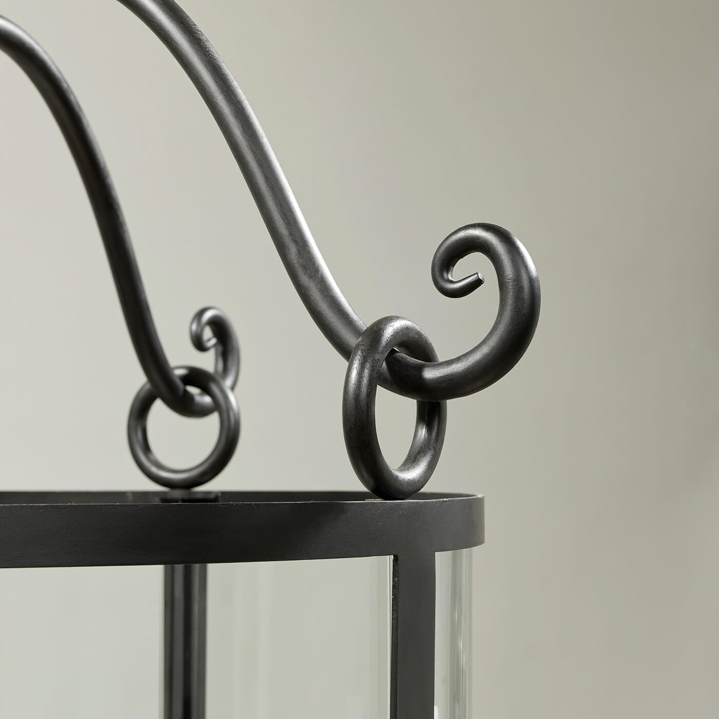Close-up of curly metalwork on rustic hall lantern.
