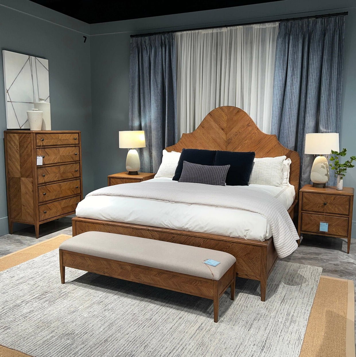 Bedroom setup featuring rustic light oak nightstand and bed.