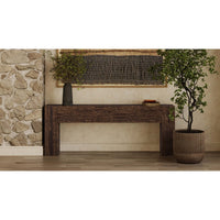Rustic minimalist console with plants and decor in hallway.