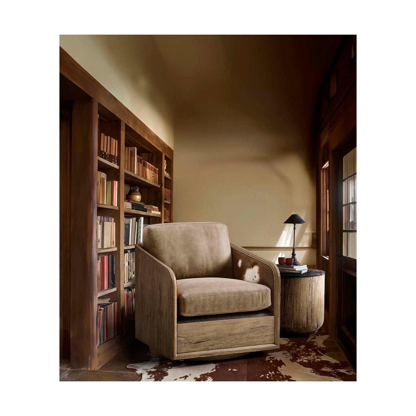Swivel armchair in cozy reading nook with table.
