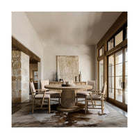 Dining room with rustic round pedestal table and chairs.