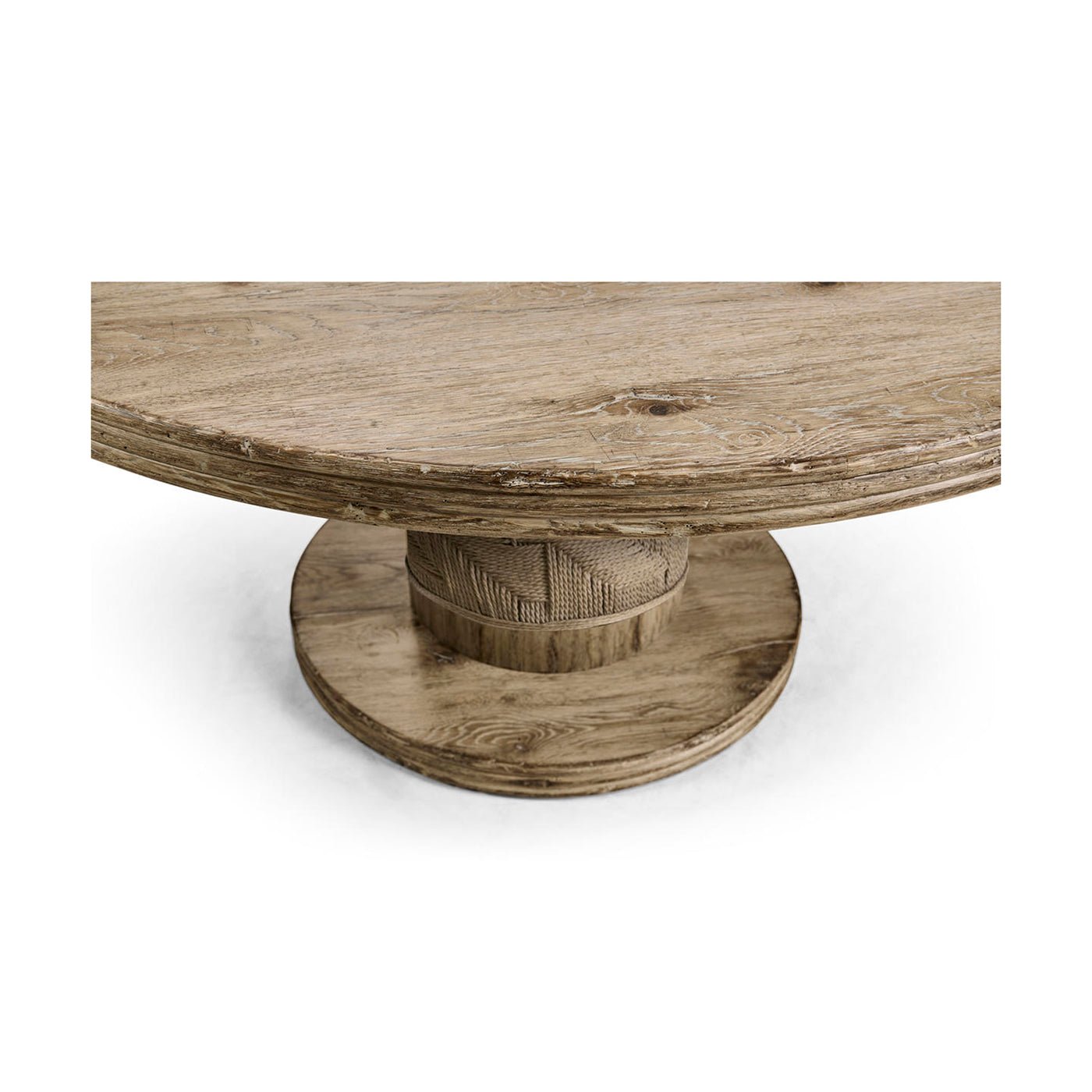 Angled view of round pedestal base on dining table.