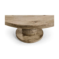 Angled view of round pedestal base on dining table.