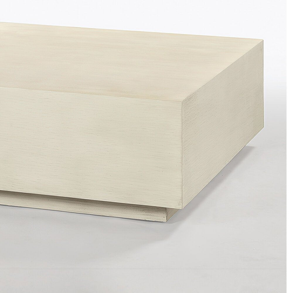 Close-up corner of square drift white coffee table.