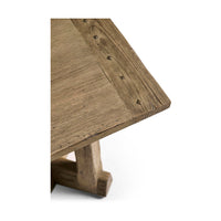 Textured surface corner of rustic table with nail details.