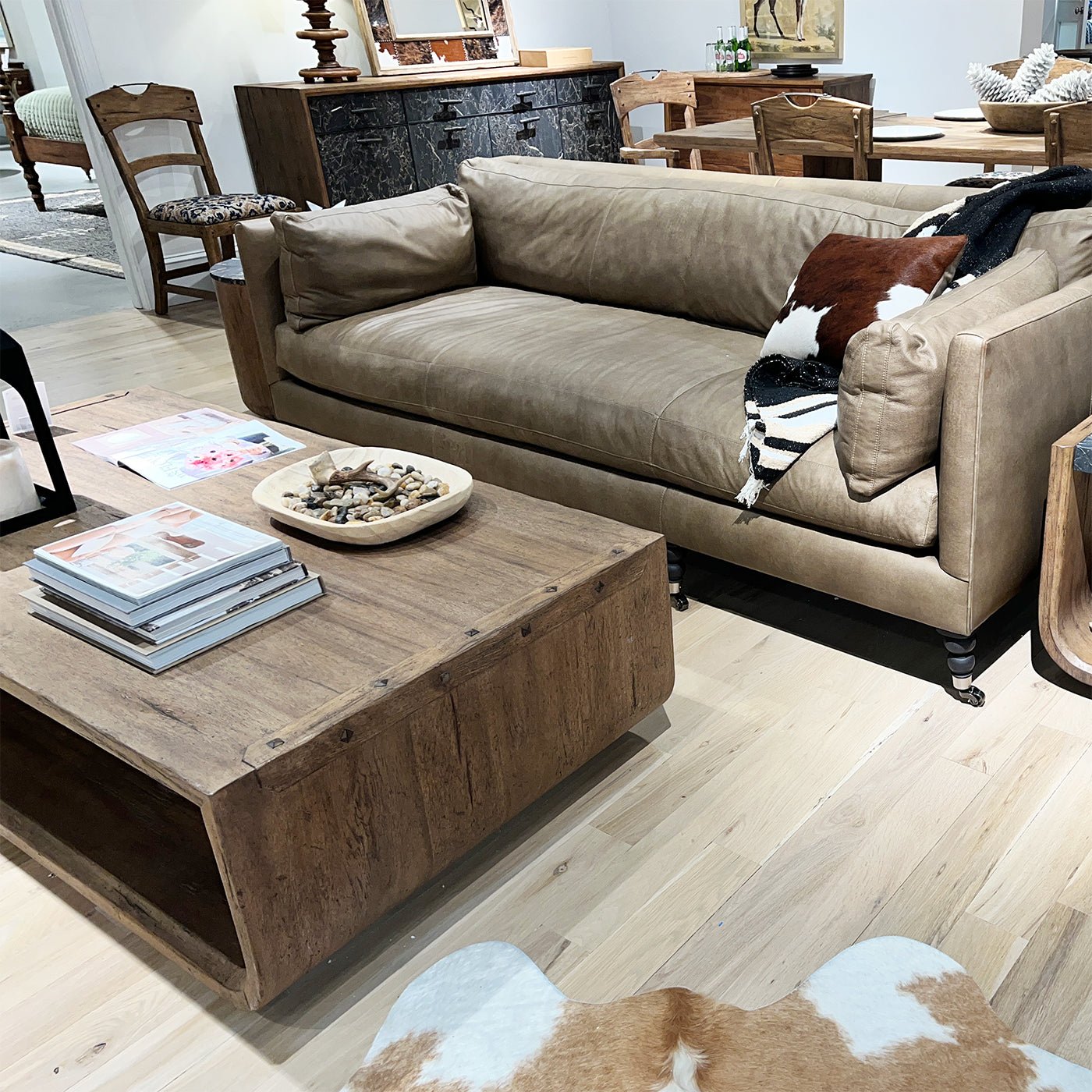 Rustic table near tan sofa and decor elements.