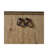 Cabinet doors with ring handles on oak buffet.