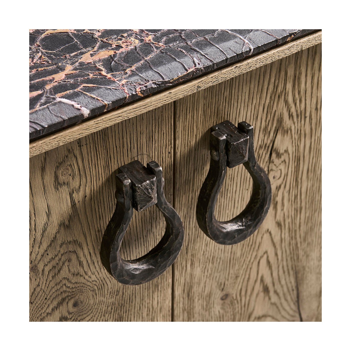 Close-up of buffet hardware and marble texture.