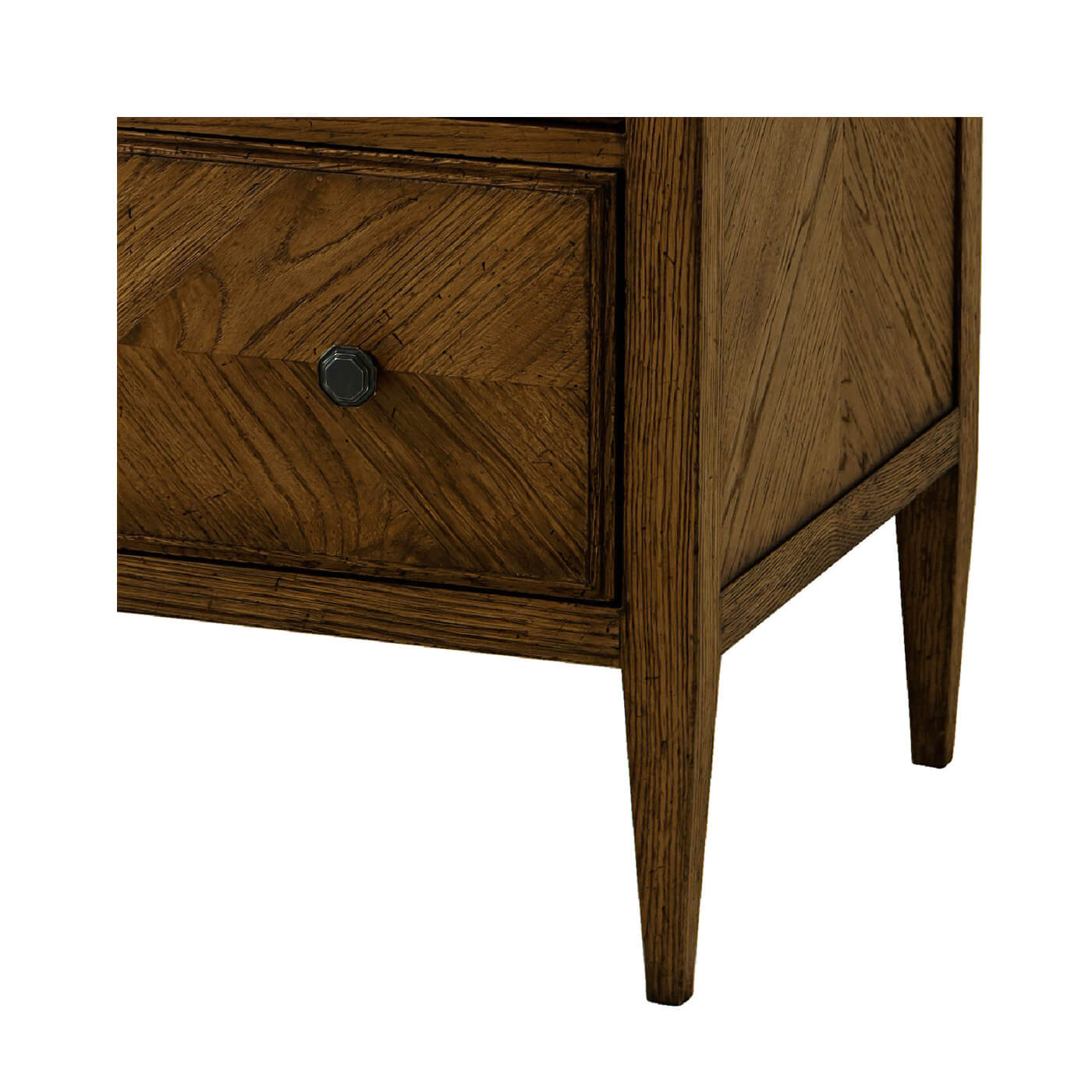 Close-up corner of rustic oak chest, leg detail.