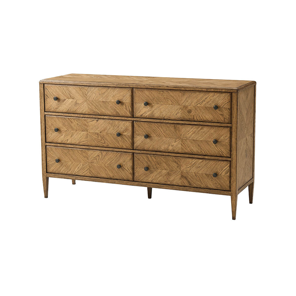 Angled view of oak parquetry dresser, six drawers visible.