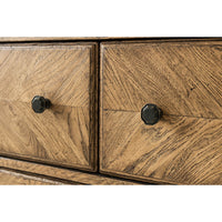 Close-up of dresser drawer knobs, oak parquetry texture.