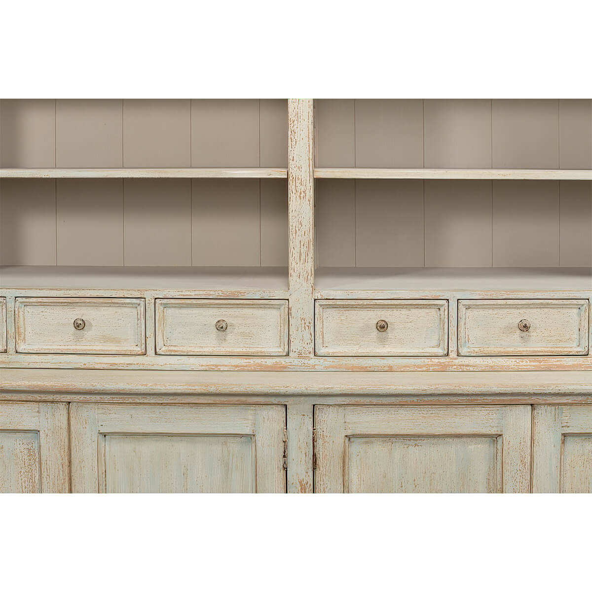 Close-up of rustic painted bookcase drawers and cabinet.