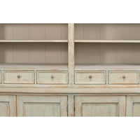 Close-up of rustic painted bookcase drawers and cabinet.