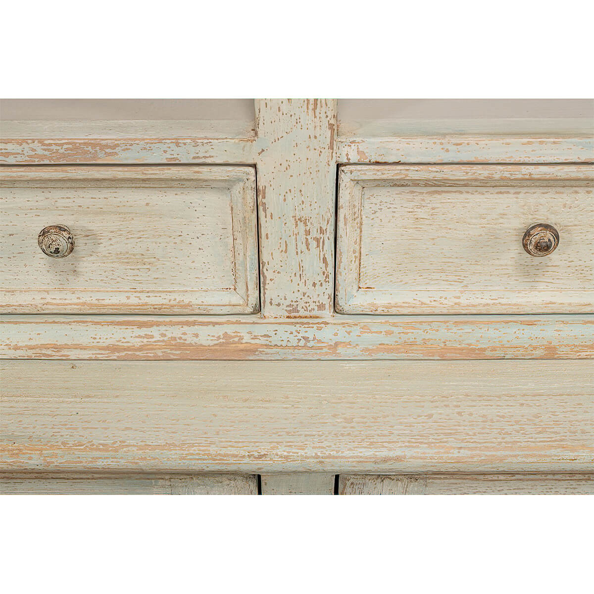 Detailed view of rustic painted bookcase drawer knobs.
