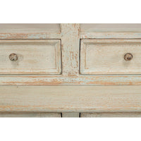 Detailed view of rustic painted bookcase drawer knobs.