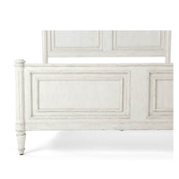 Close-up of footboard detailing on rustic queen bed.