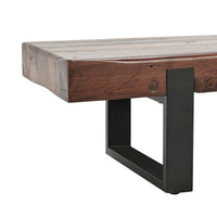 Close-up of the reclaimed wood bench showing its thick seat edge and dark rectangular iron support