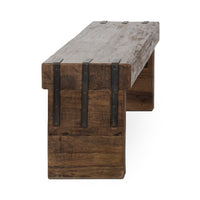 Angled end view of the reclaimed wood bench showing its weathered seat, broad legs and dark straps