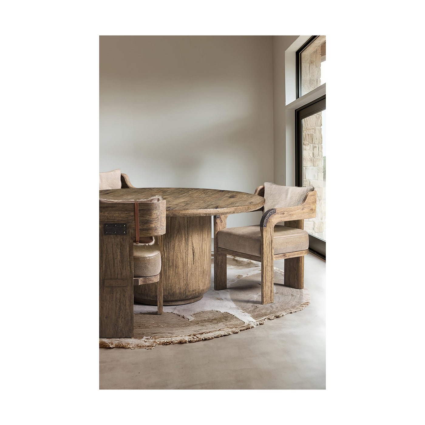 Rustic round pedestal dining table in dining room setting.