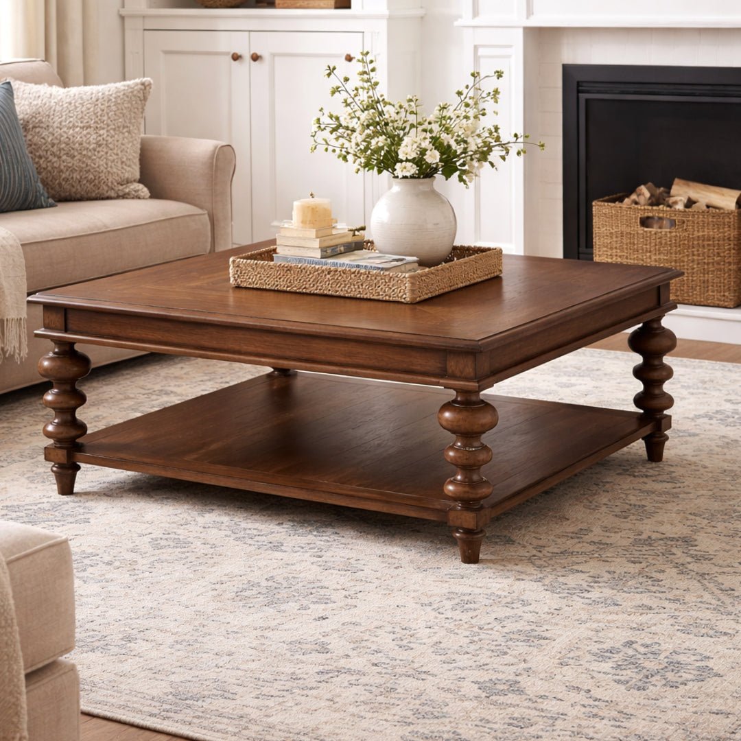 Square coffee table styled in elegant, bright living room.