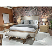Trestle bench at foot of bed in decorated bedroom.