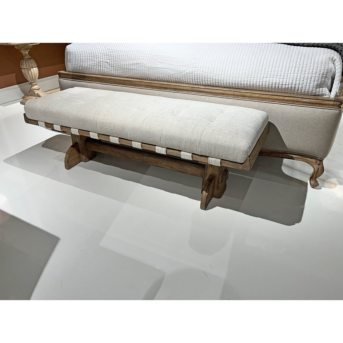 Upholstered bench close-up in bedroom setting.
