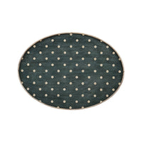 Close-up of polka dot top on oval end table.