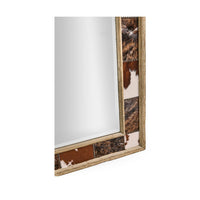 Close-up of cowhide inlay on rustic mirror frame.