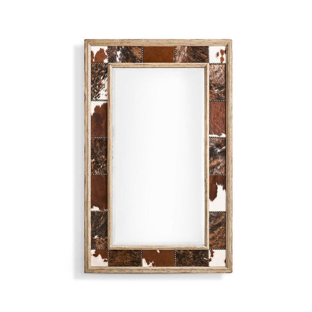Rustic cowhide inlay wall mirror on white background.
