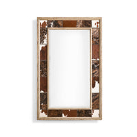 Rustic cowhide inlay wall mirror on white background.