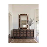 Rustic mirror over dark wooden cabinet in living space.