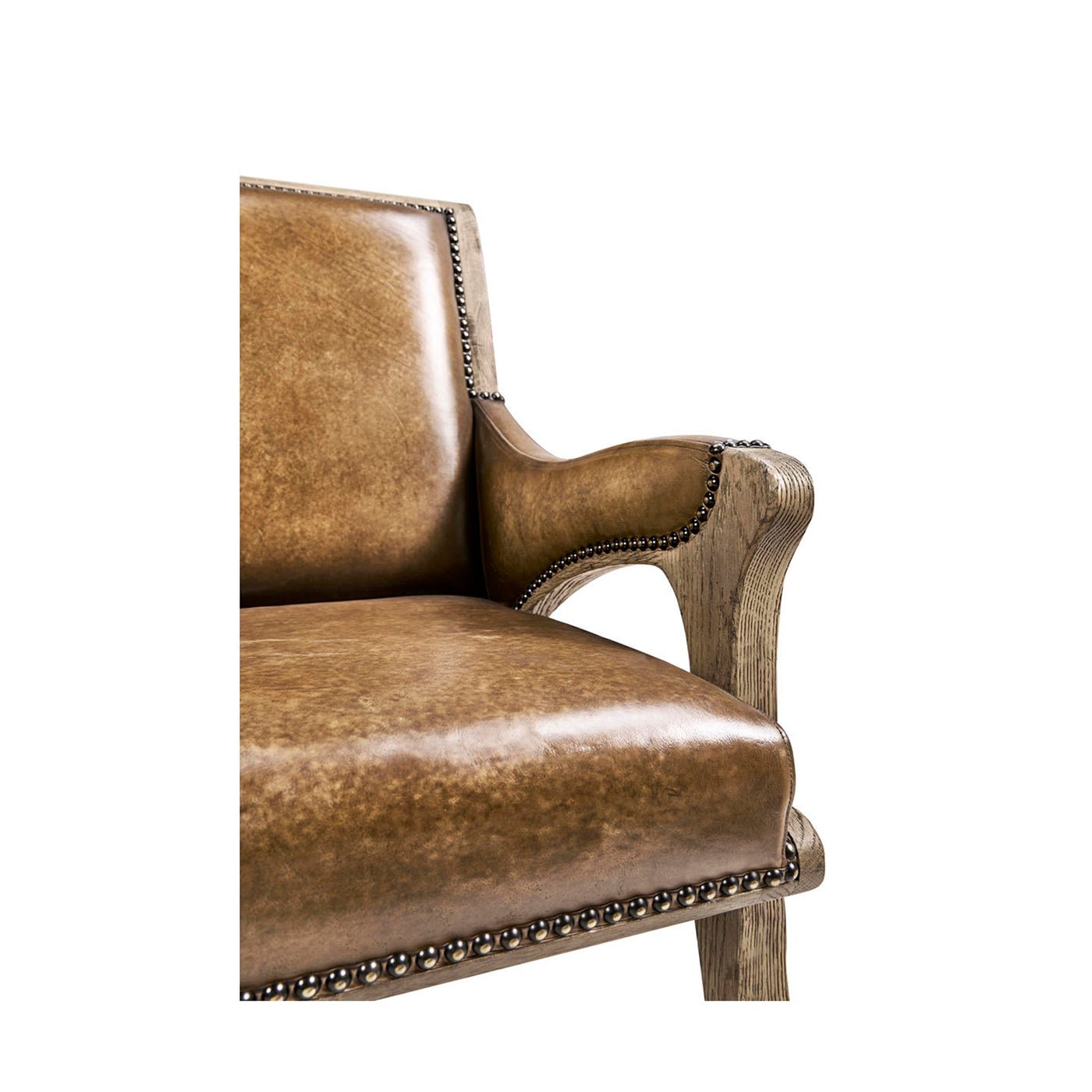 Rustic leather armchair, close-up of arm and seat.