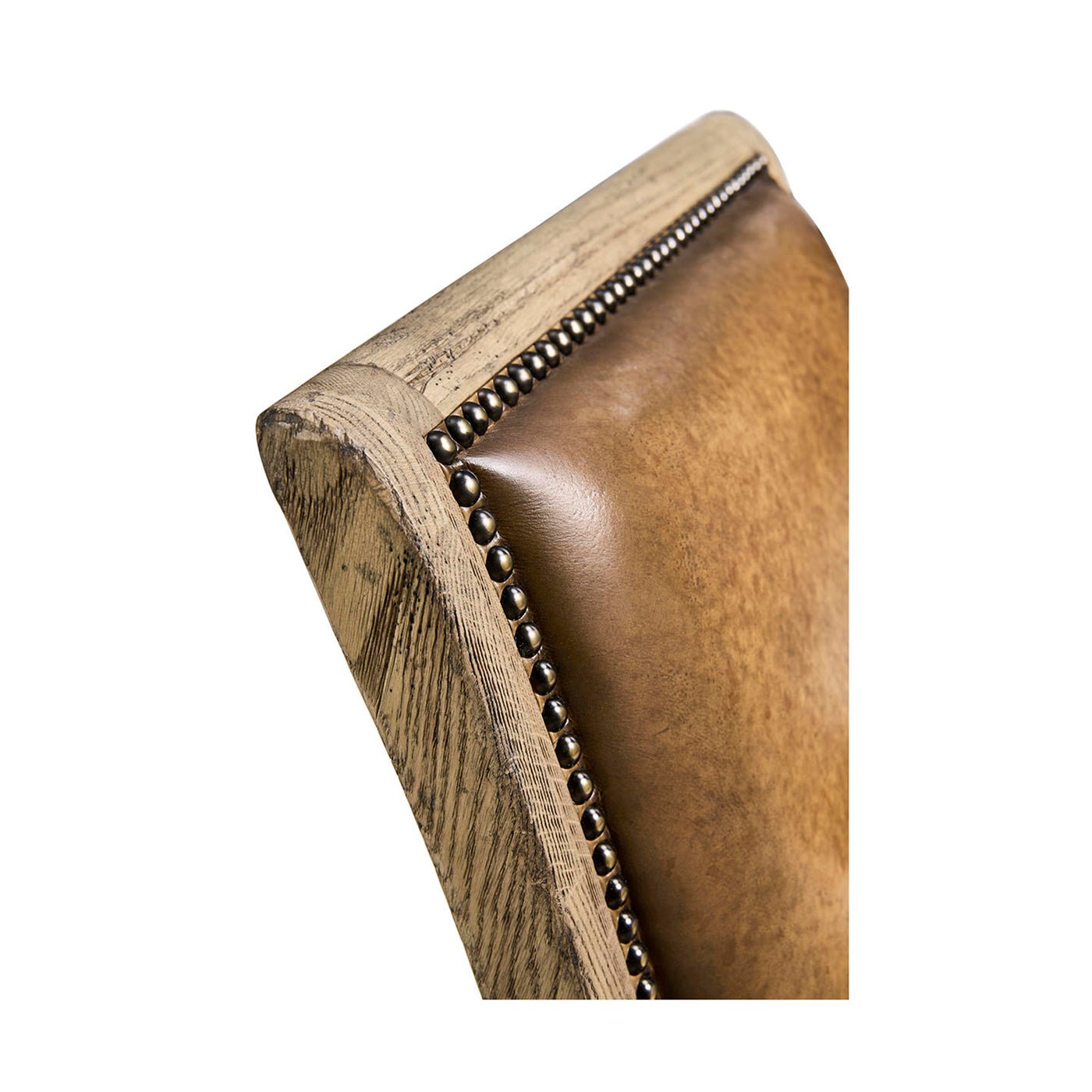 Rustic leather armchair, backrest detail with nails.
