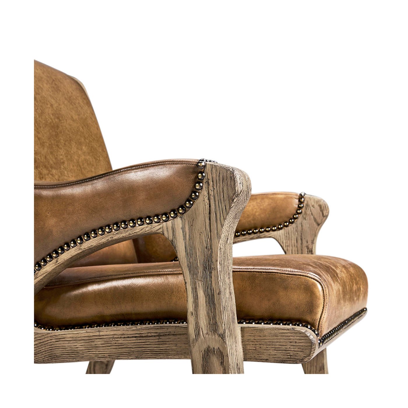 Rustic leather armchair, armrest and cushion close-up.