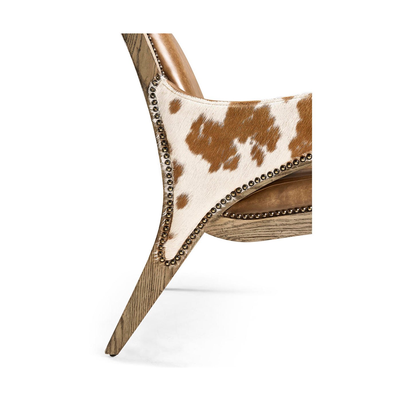 Close-up of cowhide detailing and nailhead trim on chair.