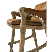 Rustic Western bar stool, armrest and seat close-up view.
