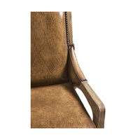 Close-up of rustic chair leather cushion and armrest design.