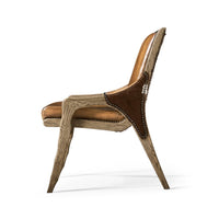 Side view of rustic western leather chair with cowhide.