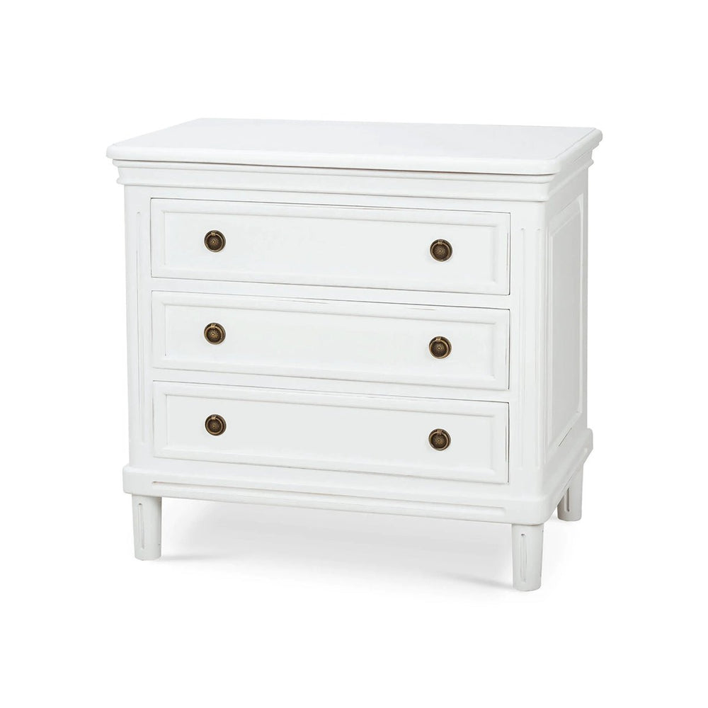 White nightstand with three drawers, angled view.