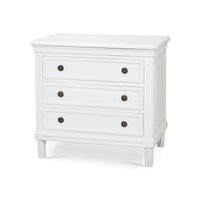 White nightstand with three drawers, angled view.