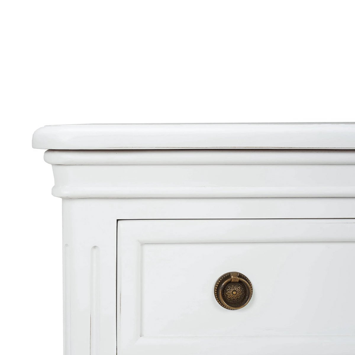 Close-up corner view of white nightstand detailing.