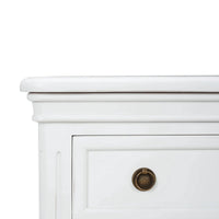 Close-up corner view of white nightstand detailing.