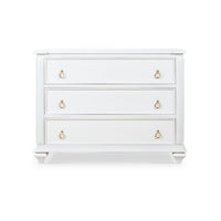 Front view of white dresser, three drawers with handles.
