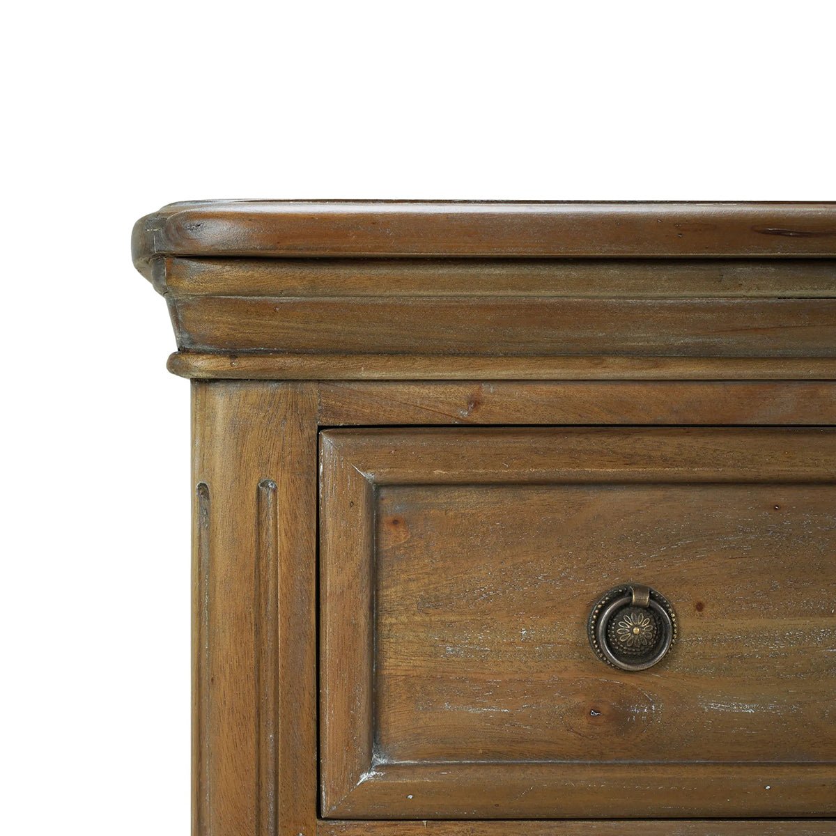Close-up of corner on rustic wood chest of drawers.
