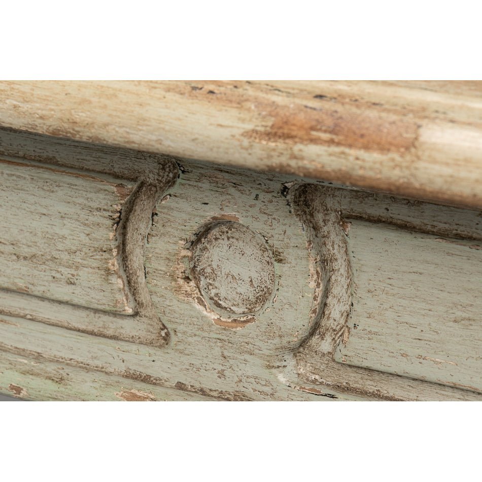 Rustic dining table, close-up of carved decoration.