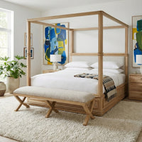 Upholstered bench in bedroom setting, next to bed.