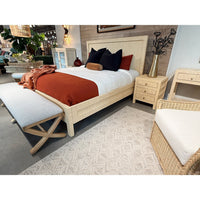 Upholstered bench in showroom, styled near bed.