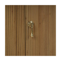 Close-up of sideboard handle on reeded wood surface.