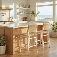 Scandinavian counter stools at kitchen island with ocean view.